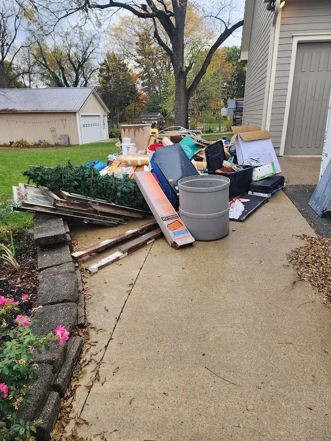 Dumpster being loaded with debris for Estate Cleanout Dumpster Rental in Melrose Park